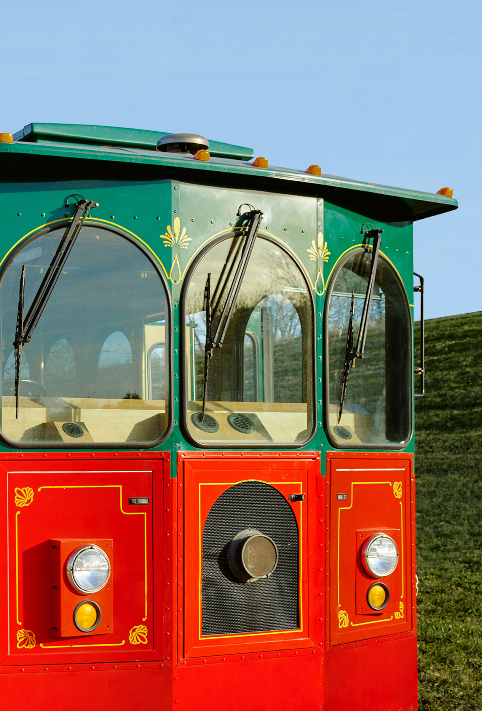 Vintage red and green trolley at sunset