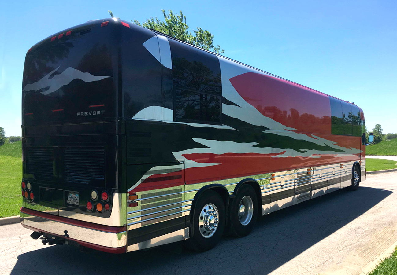 Entertainer red tour bus with red and black stripes