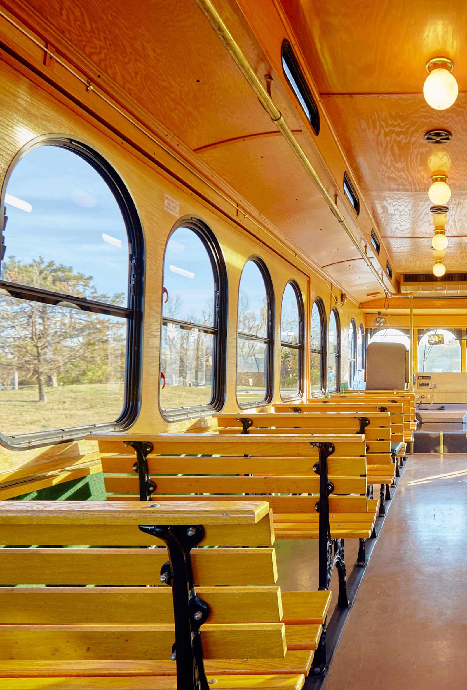Wooden aisle and brass railings inside the vintage trolley