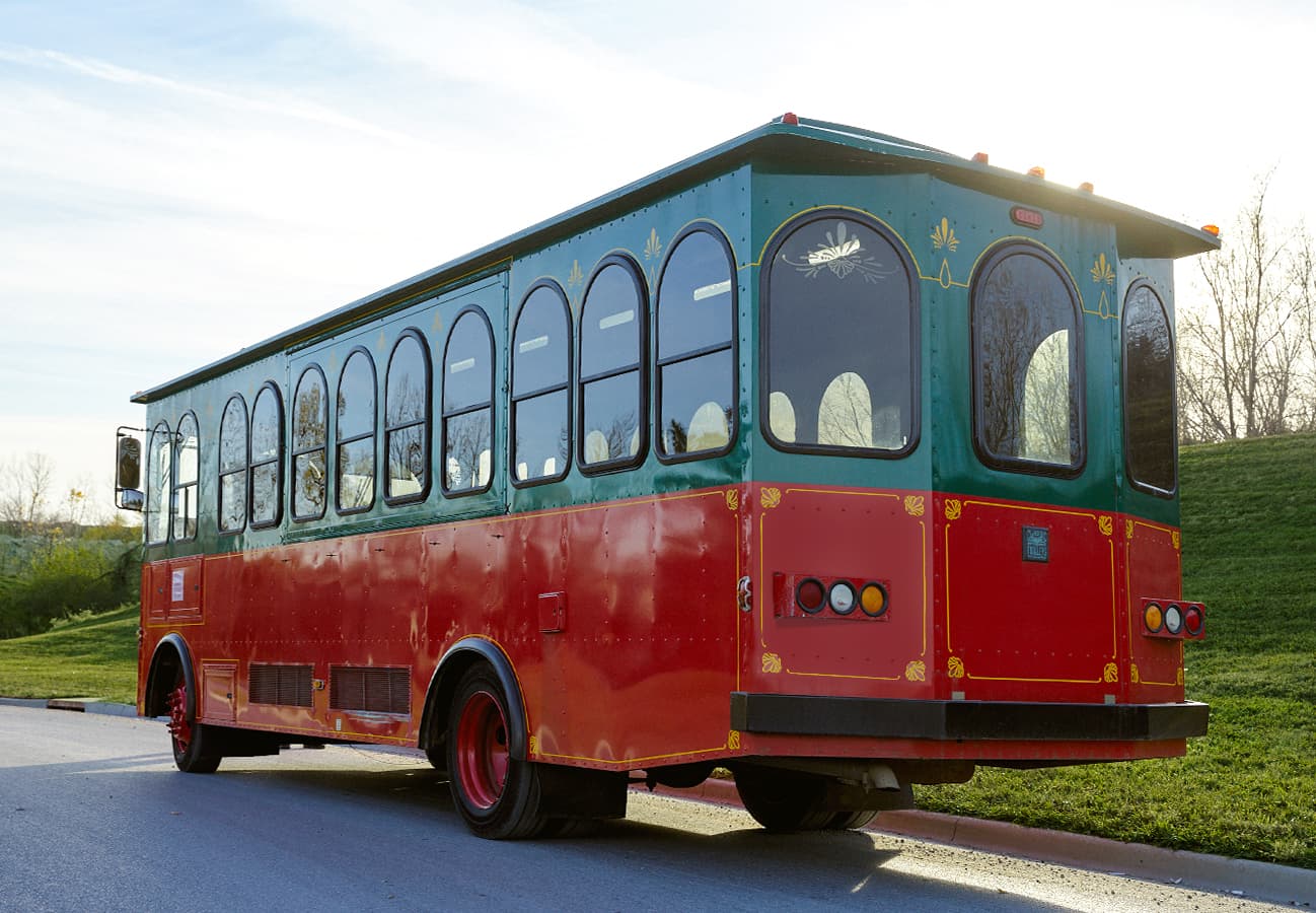 Green and red vintage trolley, rear three-quarter view
